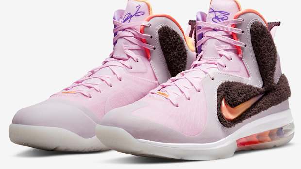 Side view of LeBron James' pink and orange Nike shoes.